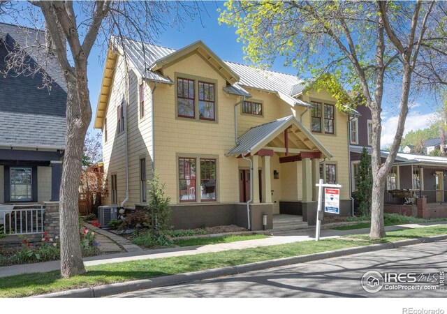 view of front of home featuring central AC unit and metal roof