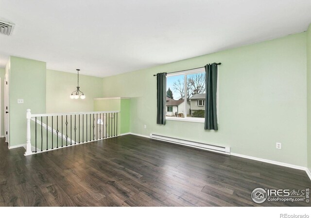 8205 Hallett Ct, Fort Collins, CO 80528 - spare room with visible vents, baseboards, a chandelier, baseboard heating, and wood finished floors