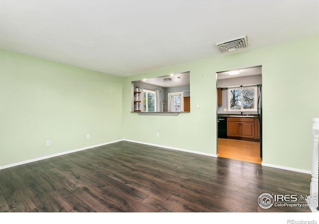 8205 Hallett Ct, Fort Collins, CO 80528 - unfurnished living room featuring a sink, visible vents, baseboards, and dark wood finished floors