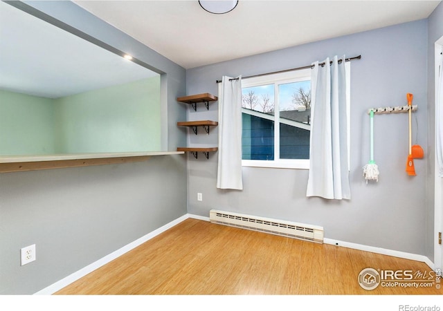 8205 Hallett Ct, Fort Collins, CO 80528 - empty room featuring baseboard heating, baseboards, and wood finished floors
