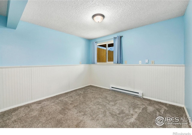 8205 Hallett Ct, Fort Collins, CO 80528 - unfurnished room with carpet floors, a baseboard heating unit, wainscoting, and a textured ceiling