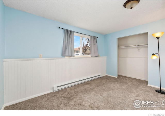 8205 Hallett Ct, Fort Collins, CO 80528 - unfurnished bedroom featuring a closet, a textured ceiling, carpet flooring, and baseboard heating