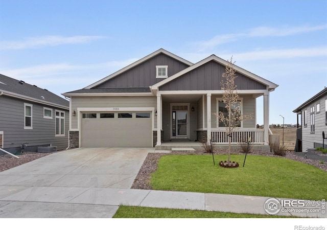 1103 Hornet Dr, Fort Collins, CO 80526 - craftsman house with covered porch, a garage, board and batten siding, concrete driveway, and a front lawn