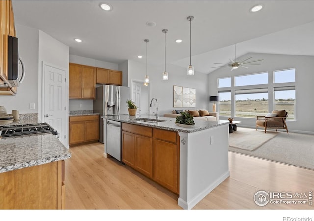 1103 Hornet Dr, Fort Collins, CO 80526 - kitchen with ceiling fan, brown cabinetry, appliances with stainless steel finishes, a sink, and open floor plan