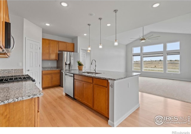 1103 Hornet Dr, Fort Collins, CO 80526 - kitchen featuring a sink, appliances with stainless steel finishes, an island with sink, a ceiling fan, and brown cabinets