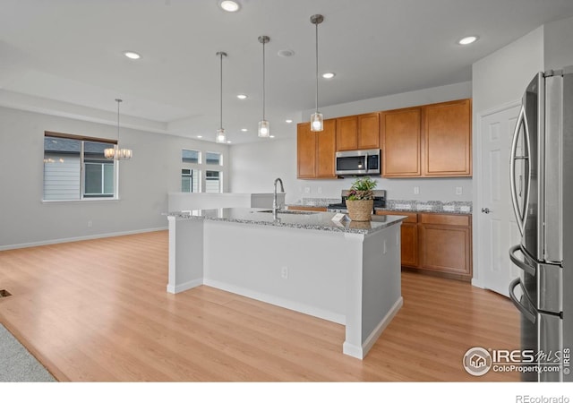 1103 Hornet Dr, Fort Collins, CO 80526 - kitchen with a sink, appliances with stainless steel finishes, recessed lighting, and brown cabinets