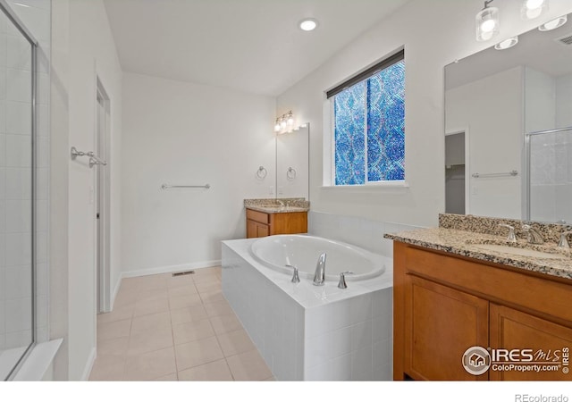 1103 Hornet Dr, Fort Collins, CO 80526 - full bath with a sink, tile patterned floors, tiled shower, visible vents, and a garden tub