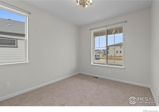 1103 Hornet Dr, Fort Collins, CO 80526 - spare room featuring visible vents, baseboards, and carpet