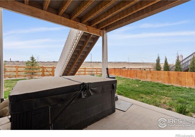 1103 Hornet Dr, Fort Collins, CO 80526 - view of patio featuring a fenced backyard, a rural view, and a hot tub