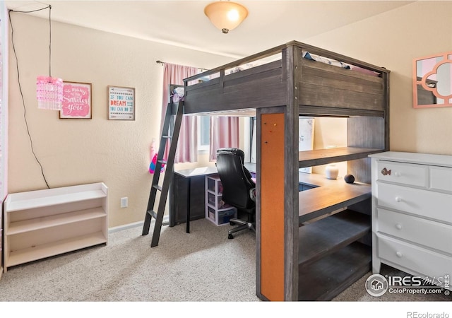 carpeted bedroom featuring baseboards
