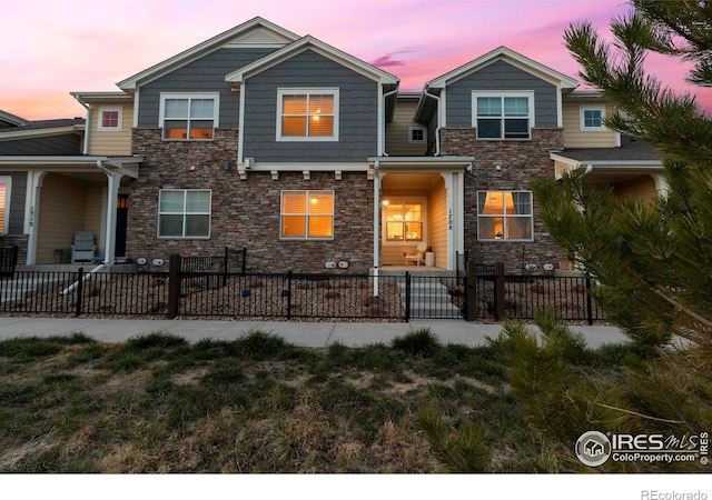 1708 W 50th St, Loveland, CO 80538 - view of front facade featuring stone siding and a fenced front yard