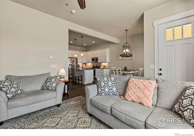 1708 W 50th St, Loveland, CO 80538 - living area with recessed lighting, a notable chandelier, and dark wood-style flooring