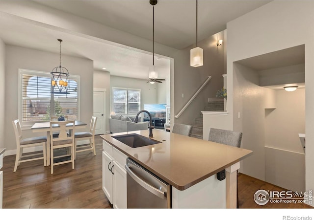 1708 W 50th St, Loveland, CO 80538 - kitchen featuring pendant lighting, stainless steel dishwasher, white cabinets, a sink, and dark wood-style floors