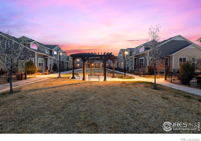 1708 W 50th St, Loveland, CO 80538 - view of playground featuring a residential view, a patio, a pergola, fence, and a lawn