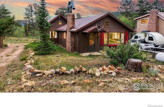 rustic home featuring a chimney