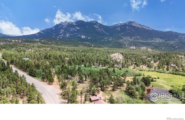 view of mountain background featuring a forest