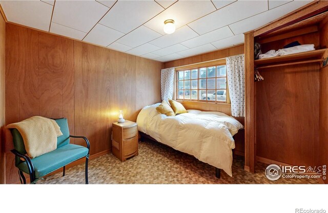 bedroom with wooden walls