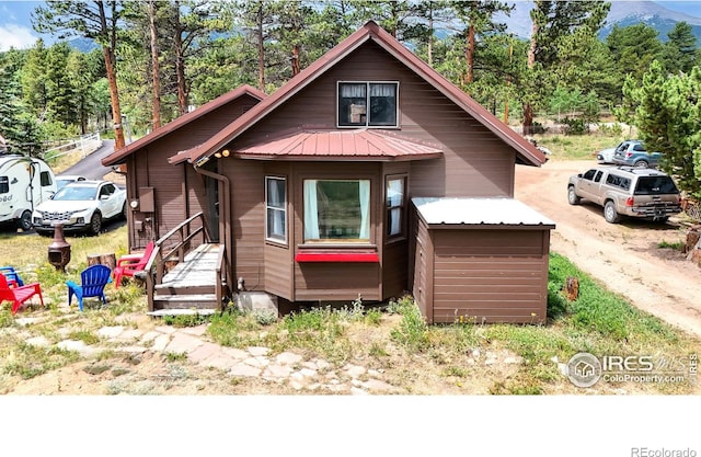 view of front of home with a mountain view and metal roof
