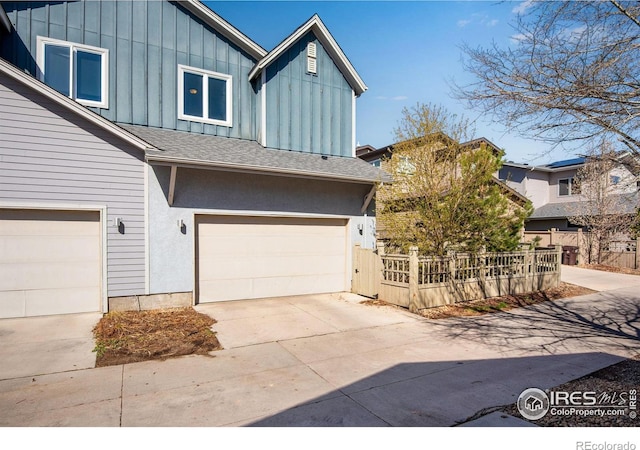 3620 Paonia St, Boulder, CO 80301 - view of front of house with roof with shingles, board and batten siding, a garage, and driveway