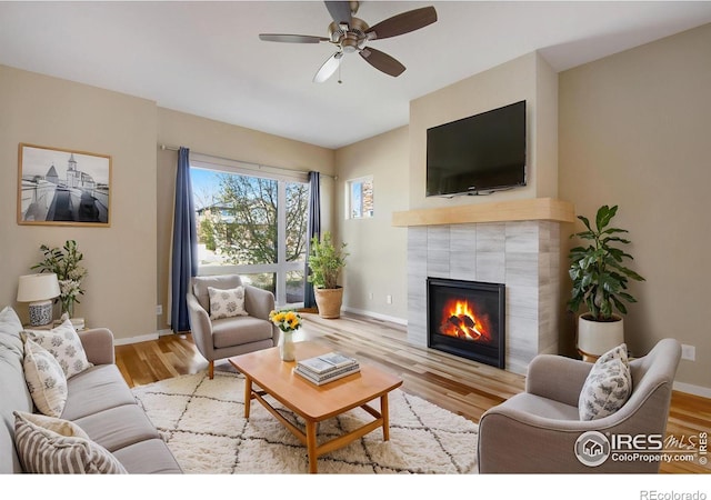 3620 Paonia St, Boulder, CO 80301 - living room with a fireplace, baseboards, a ceiling fan, and wood finished floors