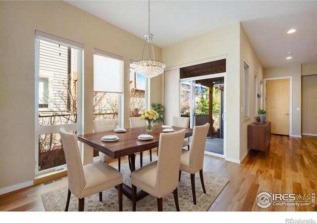 3620 Paonia St, Boulder, CO 80301 - dining space featuring baseboards, visible vents, light wood-type flooring, and an inviting chandelier