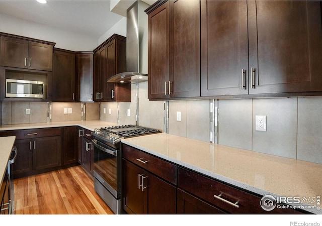 3620 Paonia St, Boulder, CO 80301 - kitchen with tasteful backsplash, light wood-style flooring, light stone countertops, wall chimney exhaust hood, and appliances with stainless steel finishes
