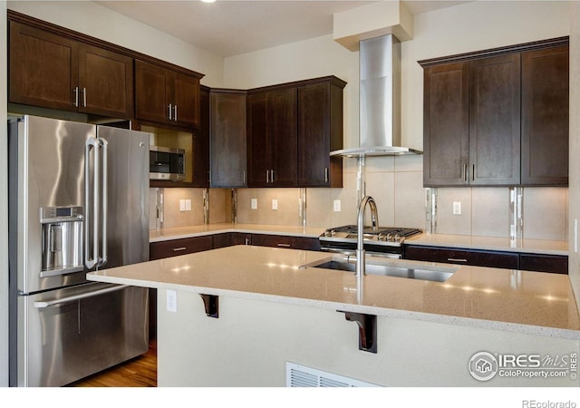 3620 Paonia St, Boulder, CO 80301 - kitchen with wall chimney exhaust hood, a sink, dark brown cabinets, and appliances with stainless steel finishes