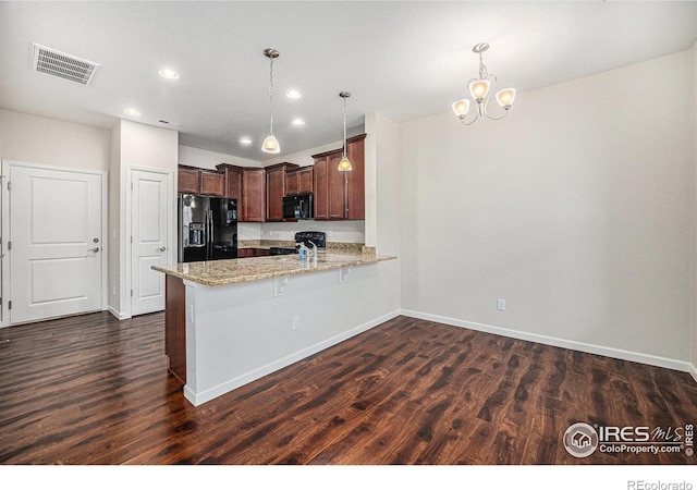 kitchen with visible vents, a peninsula, dark wood finished floors, black appliances, and light stone counters