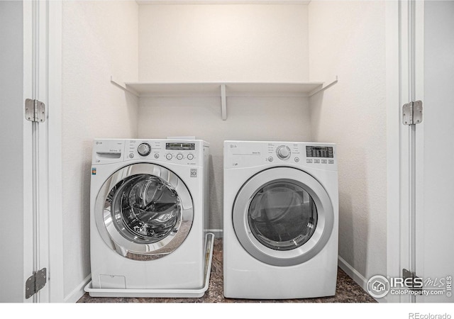 laundry room featuring washer and dryer, laundry area, and baseboards