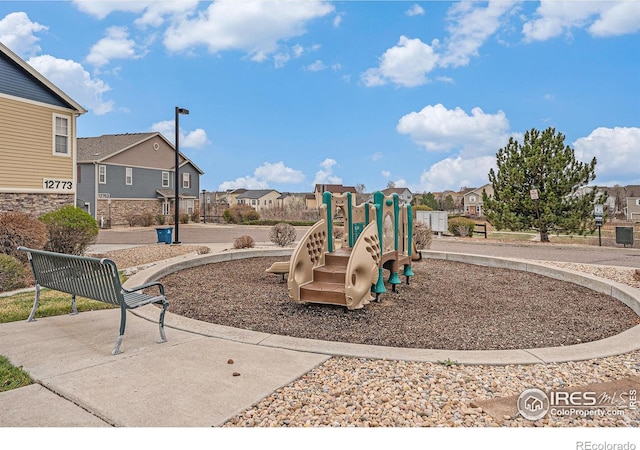 communal playground featuring a residential view