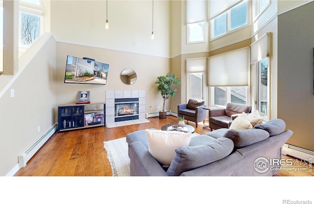 2025 Mathews St Unit 3, Fort Collins, CO 80525 - living room with a baseboard heating unit, plenty of natural light, a high ceiling, and a fireplace