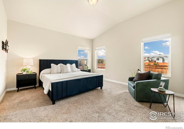 bedroom featuring carpet flooring, multiple windows, and vaulted ceiling