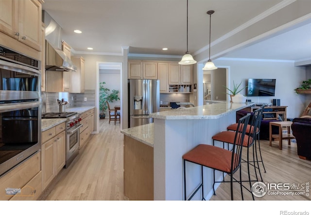 4921 Fountain St, Boulder, CO 80304 - kitchen featuring appliances with stainless steel finishes, a kitchen breakfast bar, light brown cabinets, crown molding, and light wood finished floors
