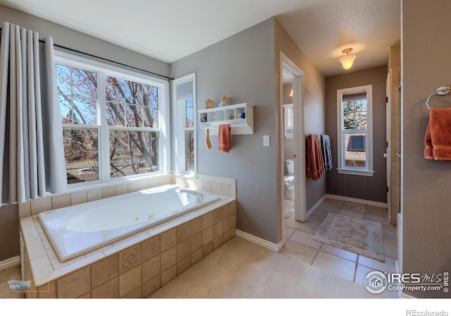 4921 Fountain St, Boulder, CO 80304 - full bath featuring toilet, a whirlpool tub, baseboards, and tile patterned flooring