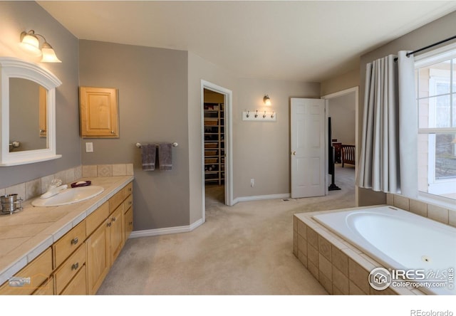 4921 Fountain St, Boulder, CO 80304 - full bathroom featuring vanity, a bath, baseboards, and a walk in closet