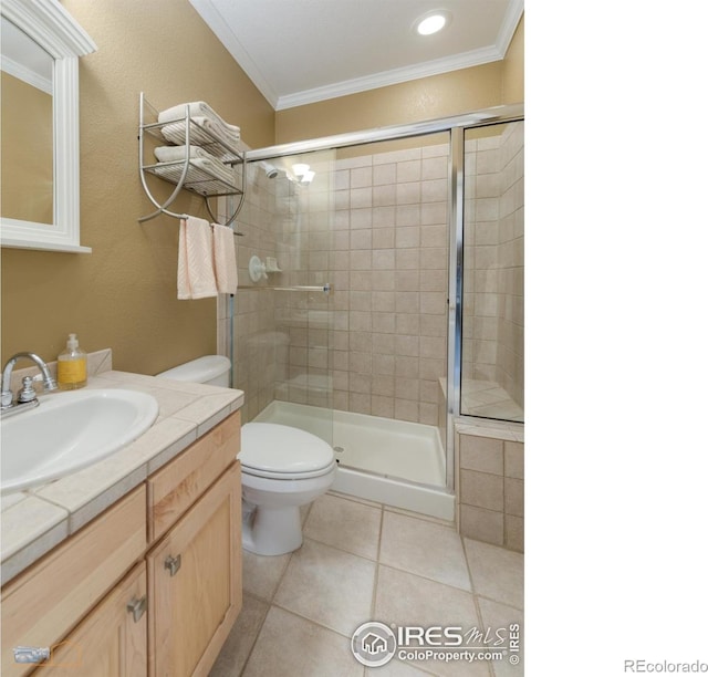 4921 Fountain St, Boulder, CO 80304 - bathroom with ornamental molding, vanity, toilet, a shower stall, and tile patterned floors