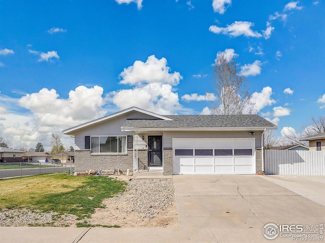 3735 W 8th St, Greeley, CO 80634 - ranch-style home with a garage, fence, a front lawn, brick siding, and concrete driveway