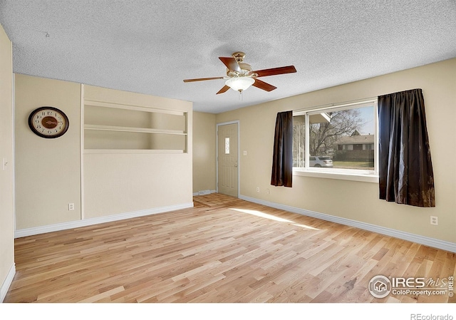 3735 W 8th St, Greeley, CO 80634 - spare room with a textured ceiling, wood finished floors, ceiling fan, and baseboards