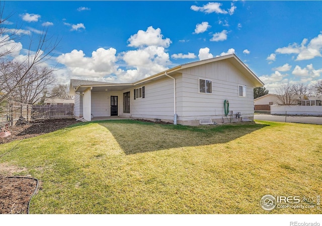 3735 W 8th St, Greeley, CO 80634 - rear view of house featuring fence and a lawn