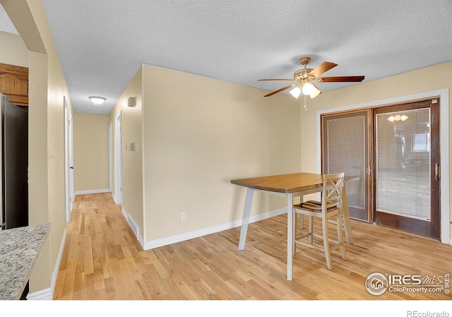 3735 W 8th St, Greeley, CO 80634 - dining space featuring baseboards, light wood-type flooring, a textured ceiling, and ceiling fan