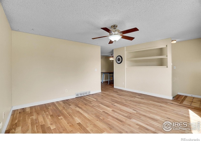 3735 W 8th St, Greeley, CO 80634 - unfurnished room featuring visible vents, ceiling fan, wood finished floors, and a textured ceiling