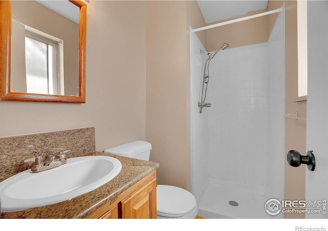 3735 W 8th St, Greeley, CO 80634 - bathroom with tiled shower, vanity, and toilet