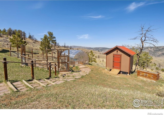 13236 Otter Rd, Loveland, CO 80538 - view of yard featuring a greenhouse and a mountain view