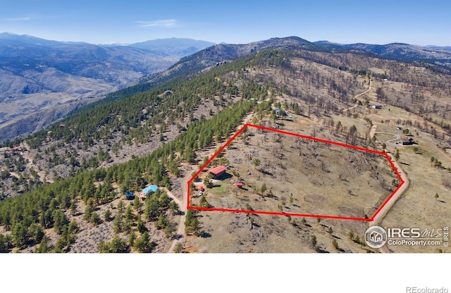 13236 Otter Rd, Loveland, CO 80538 - aerial view of property and surrounding area with a mountainous background and property boundaries highlighted