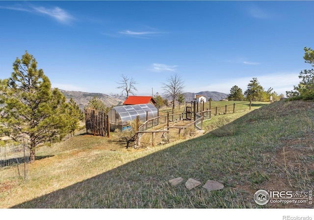 13236 Otter Rd, Loveland, CO 80538 - view of yard featuring an exterior structure, a mountain view, and an outbuilding