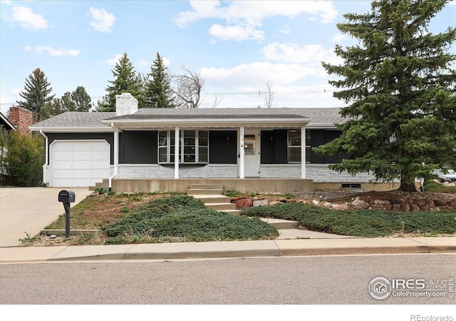 2610 Heidelberg Dr, Boulder, CO 80305 - ranch-style house featuring a chimney, a porch, a garage, and concrete driveway