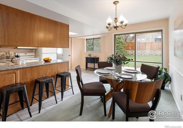 2610 Heidelberg Dr, Boulder, CO 80305 - dining space featuring baseboards, a notable chandelier, and light tile patterned flooring