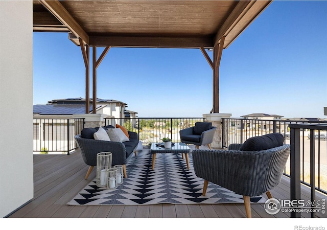 wooden terrace with an outdoor hangout area