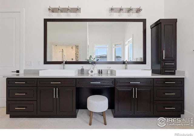 bathroom featuring a sink and double vanity