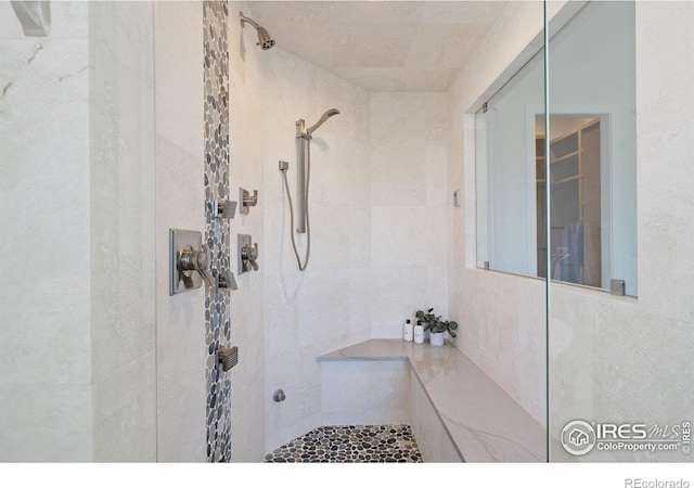 bathroom with a tile shower